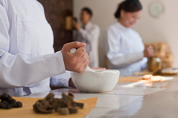 Traditional Chinese doctors mixing medicine ingredients